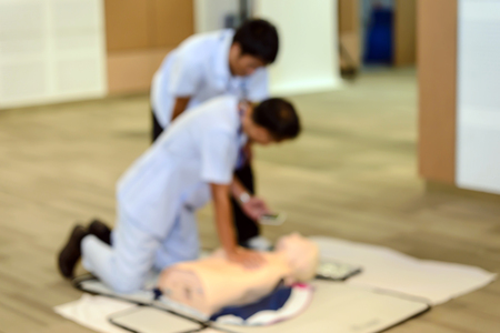 Abstract blurred image of CPR First Aid Training with CPR dummy in the classの写真素材