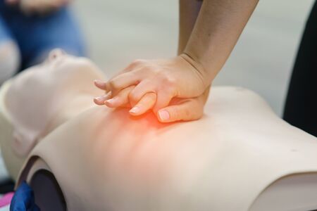 CPR First Aid Training with CPR dummy in the class