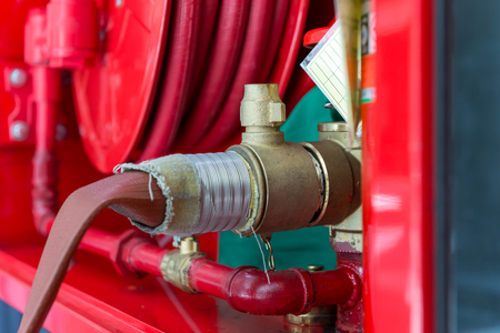 high pressure water pump valve with fire hose to cabinet on the wall