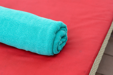 New towels on a sun-bed near a swimming pool.の写真素材