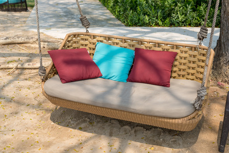 Hanging chair with pillow on the beachの写真素材