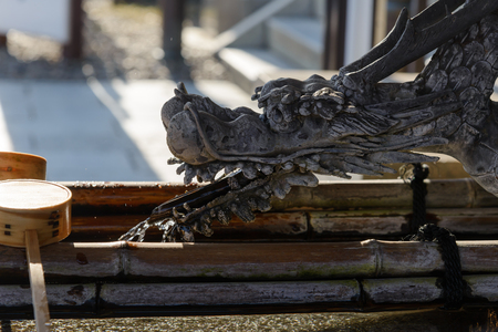 Narita, Chiba, JAPAN - July, 2018: Water from mouth of dragon for cleansing ceremony, hand wash pavilion before enter the shrine gate at Narita-san Shinshoji temple Narita, Chiba, Japanのeditorial素材