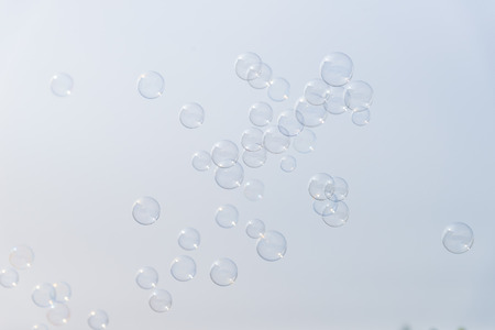 Soap bubbles in the air with cloud and blue sky on background, Outdoor activity funny and party