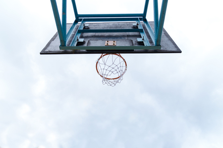 Under basketball hoop outdoors at cloudy day. Sport conceptの写真素材