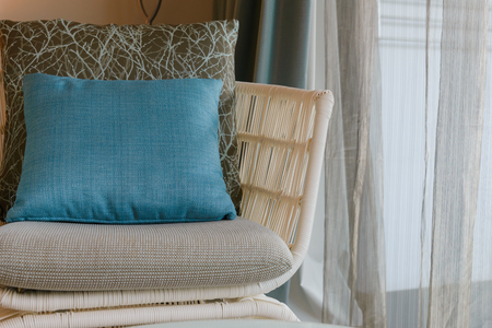 modern wicker chair with cushion and comfort pillow in room. Near by the windowの写真素材