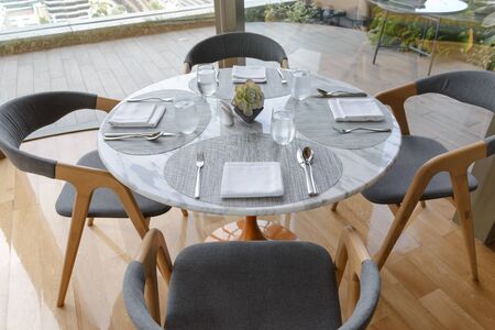 Table setting in the restaurant. Decorated elegant table, glasses, napkin, knife, fork and spoon