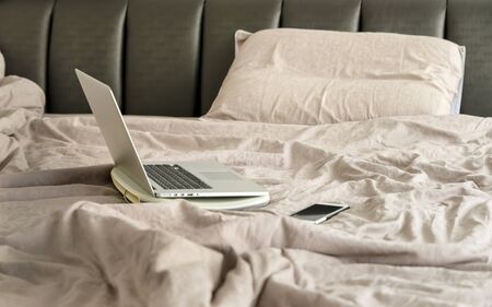Laptop on bed. work at home or working frome home concept.の写真素材