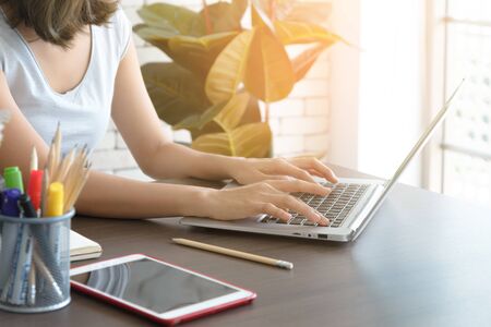 Close up hand of woman working with computer laptop at home. Work at home concept