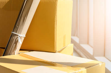 stack of Cardboard near big window inside of modern living roomの写真素材