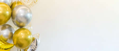 Golden and Silver colour balloons on white background with copy space for party decoration, New Year...
