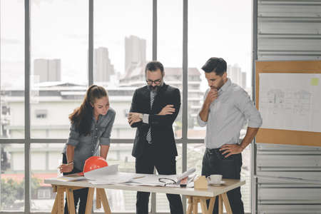 Engineers team meeting for architectural project. architects discussing blueprint with construction manager in office worker conference site. Construction Conceptの写真素材
