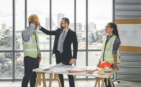 Engineers team meeting for architectural project. architects discussing blueprint with construction manager in office worker conference site. Construction Conceptの写真素材