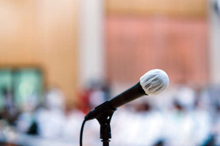 Close up of microphone over abstract blurred of attendee in seminar room or conference hallの写真素材