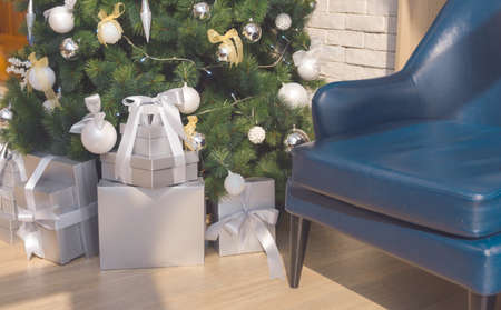 Presents and gifts under christmas tree in living room. Christmas time and Happy New Year celebration, Winter Holiday Conceptの写真素材