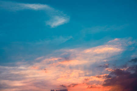 Sunbeams breaking through the clouds with blue and orange sky. Hope, prayer concept for backgroundの写真素材