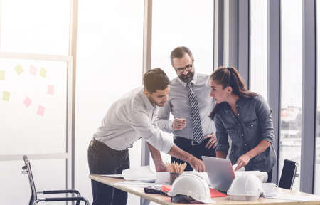 Engineers team meeting for architectural project. architects discussing blueprint with construction manager in office worker conference site. Construction Conceptの写真素材