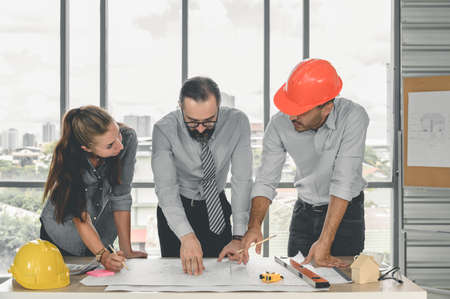 Engineers team meeting for architectural project. architects discussing blueprint with construction manager in office worker conference site. Construction Conceptの写真素材