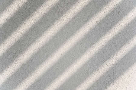 Abstract  shadow lines from the curtain on the white wall. Background, wall art, design presentationの写真素材