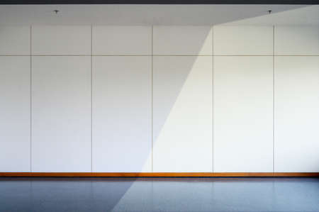 Empty room interior with black floo, white wall background and Fire sprinkler on ceiling. sunlight in room. Free space for display or montage products.の写真素材