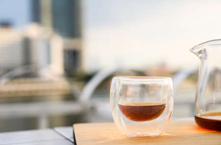 Drip freshly brewed coffee in a cup and glass pot on wooden tray. Hot brew coffee drink is good for health, Natural light. copy spaceの写真素材