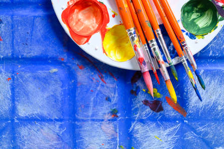 Top view of painters brushes on plastic palette with colorful watercolour. Copy spaceの写真素材