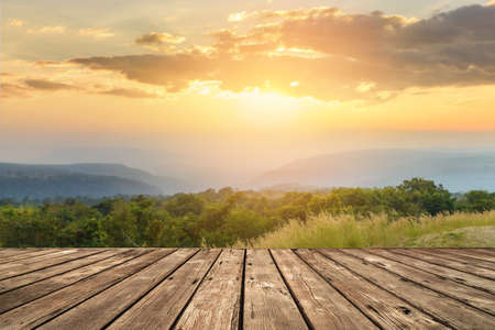 landscape of mountains valley during the sunset with wooden top table for product displayの写真素材