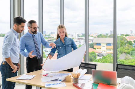Engineers team meeting for architectural project. architects discussing blueprint with construction manager in office worker conference site. Construction Conceptの写真素材