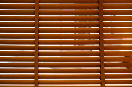 open wooden venetian blinds. lighting range control sunlight coming from a window. decoration...