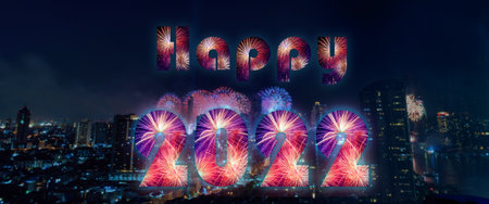 Happy New Year 2022. Happy 2022 lettersÂ made of fireworks with cityscape on background. Starting...
