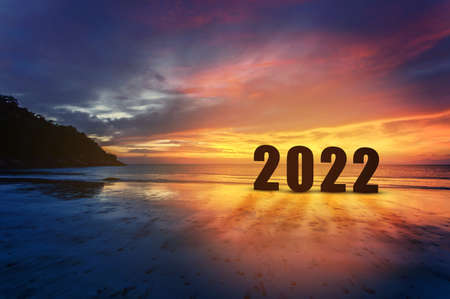 Silhouette number of 2022 letters with sunset beach on background. Starting to New Year conceptの写真素材