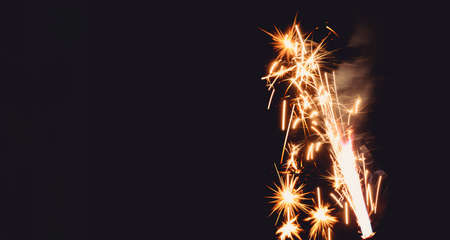 Burning flare or flame with bright sparks and smoke from a burnt candle on background with copy...