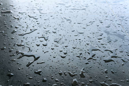 water drop on the black ceramic tile floor after taking a bathの写真素材