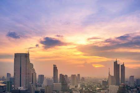 Cityscape of modern buildings and urban architecture. Aerial view of Bangkok city at twilight sunset...