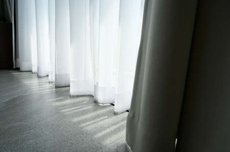 Through sheer window curtain and curtain over marble floor. Home interior design conceptの写真素材