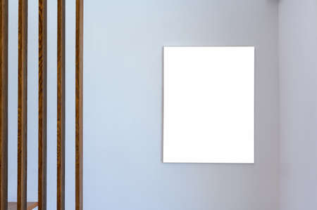 Home interior wooden lath and white poster frame on white wall. blank picture frame free space for...