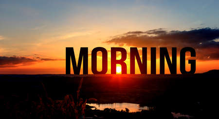 Silhouette MORNING letters on the mountain with sunset on mountains landscape in twilight time. Starting to a good dayの写真素材