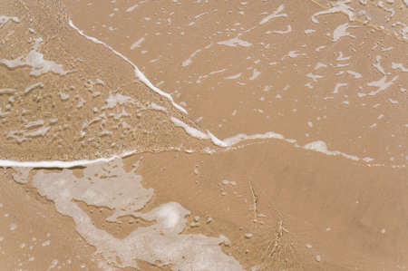 Above view of soft wave on sandy beach seaside. summer vacation activity  background concept