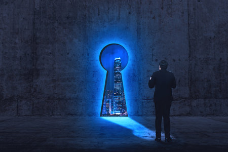 Back view of businessman in front of keyhole opening to city view in the night time. Key to access and success conceptの写真素材