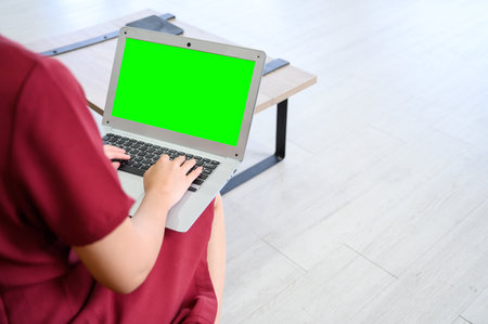 Manager woman working at mockup green screen chroma key laptop with isolated display. businesswoman sitting and working with laptop computerの写真素材