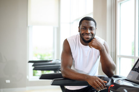 portrait of healthy black man in fitness sports club. African American smiling and looking at the cameraの写真素材