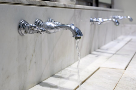 Water tap, Water drop from chrome faucet to washbasin. Hygiene conceptの写真素材