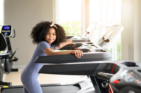 Portrait of happy African American girl in a gym. Sport, healthy lifestyle, active childhood concept. Look at cameraの写真素材
