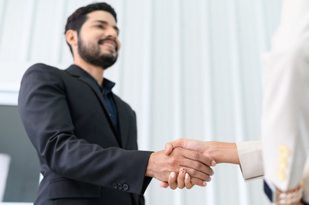 business partners shaking hands after concluding a business finished. Businessman and Businesswoman handshake in the meeting room. Business to succeed concept, Collaborative teamworkの写真素材