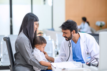 Pediatrician doctor consulting Asian mother about her little son health. Mother and son talking to...