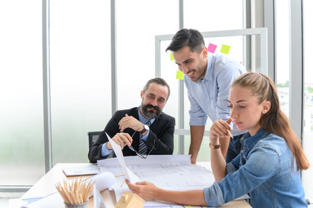 Construction engineer and architect check plan working with the blueprint on office worker...