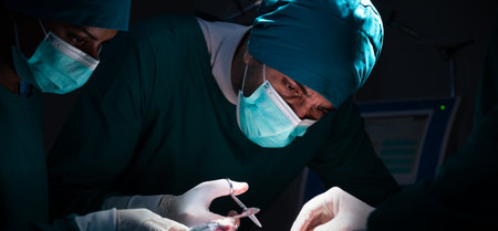 Group of concentrated surgical doctor team doing surgery patients in hospital operating theater....