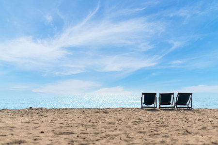 Relax time on the beach. beach chaise set up for travelers on the beach in Thailand with blue sky on sunny days. Summer vacation and holidayの写真素材