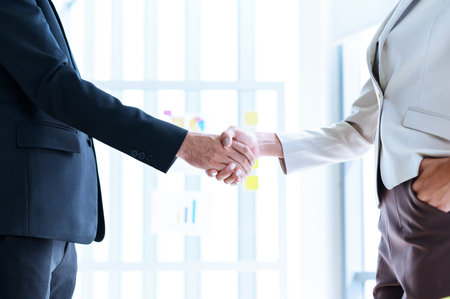 closeup of business partners shaking hands after concluding a business finished. Businessman and Businesswoman handshake in the meeting room. Business to succeed concept, Collaborative teamworkの写真素材