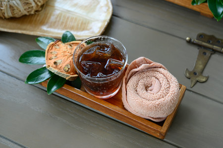 Welcome drink. Icy Bael Juice with cold towel and dry Bael desolate on wooden trayの写真素材