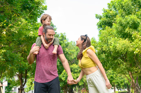 Happy Family. father, mother with little child in the park on a sunny summer day together. Son...